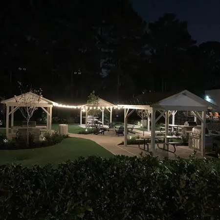 a front view of a house with yard and outdoor seating