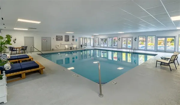 a living room with furniture pool table and a flat screen tv
