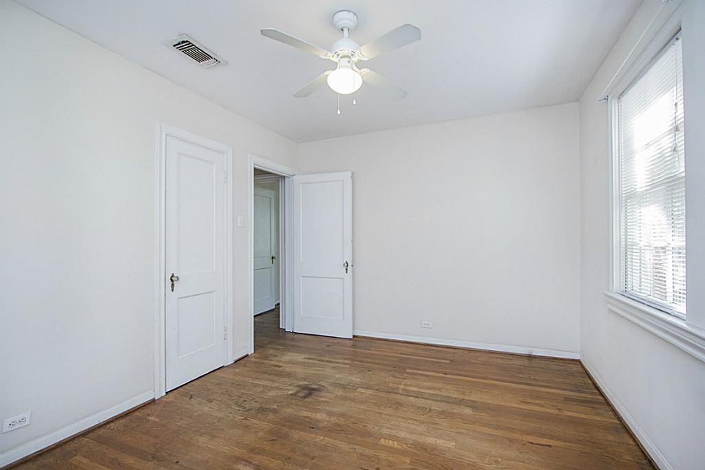 1843 Branard Street, Unit A Houston, TX 77098 - Photo 11 of 19 wooden floor in an empty room with a window