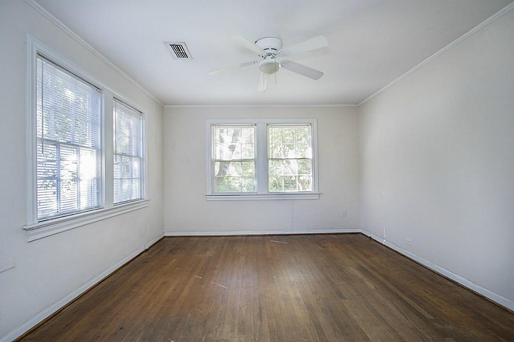 1843 Branard Street, Unit A Houston, TX 77098 - Photo 15 of 19 a view of an empty room with wooden floor and a window