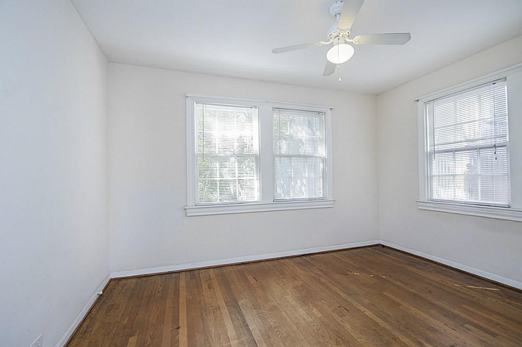 1843 Branard Street, Unit A Houston, TX 77098 - Photo 16 of 19 wooden floor in an empty room with a window