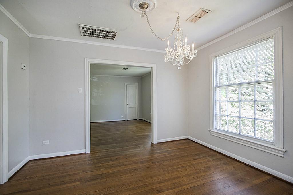 1843 Branard Street, Unit A Houston, TX 77098 - Photo 17 of 19 a view of an empty room with wooden floor and a window