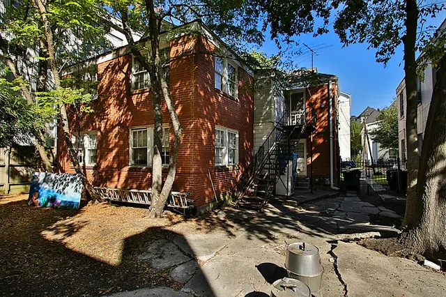 a view of a house with a snow on the road