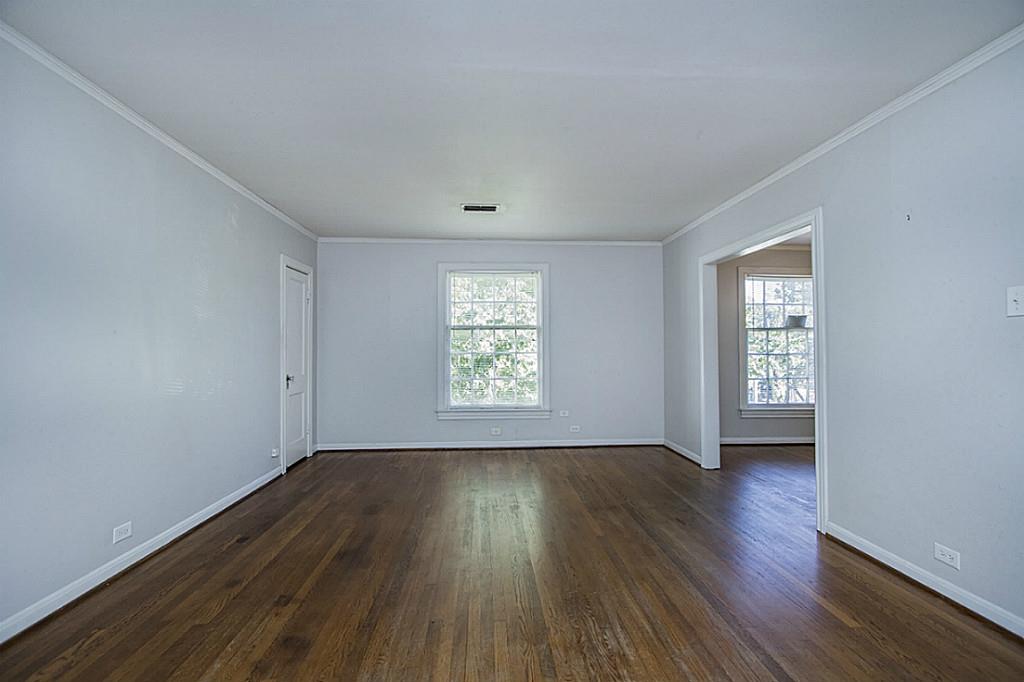 1843 Branard Street, Unit A Houston, TX 77098 - Photo 4 of 19 an empty room with wooden floor and windows