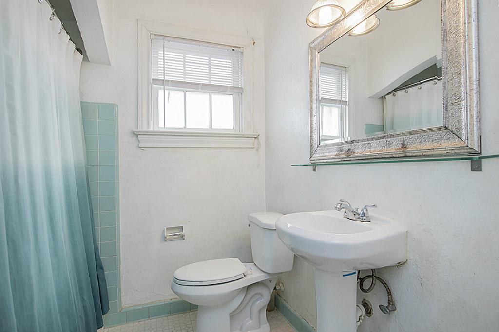 1843 Branard Street, Unit A Houston, TX 77098 - Photo 7 of 19 a bathroom with a sink toilet and a mirror