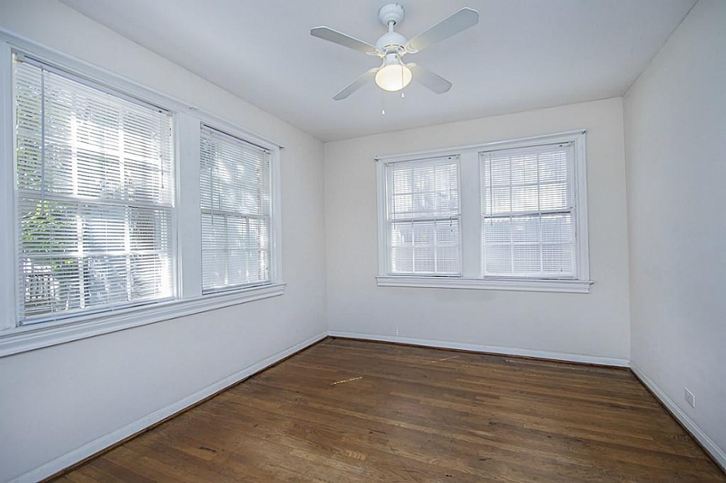 1843 Branard Street, Unit A Houston, TX 77098 - Photo 8 of 19 wooden floor in an empty room with a window