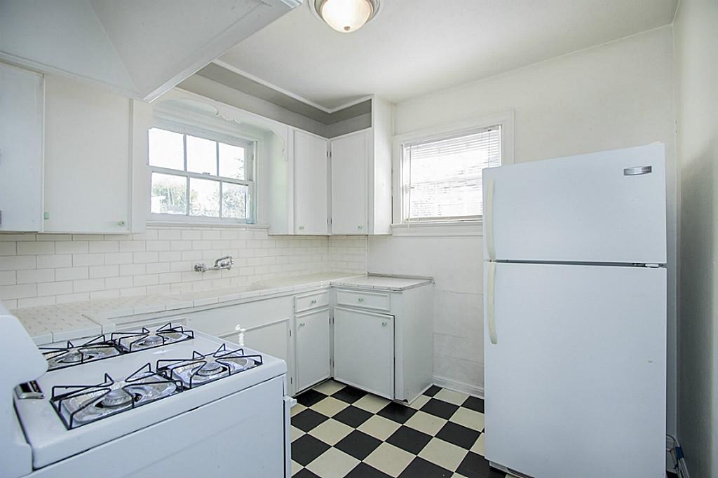 1843 Branard Street, Unit A Houston, TX 77098 - Photo 9 of 19 a kitchen with a refrigerator sink stove and cabinets