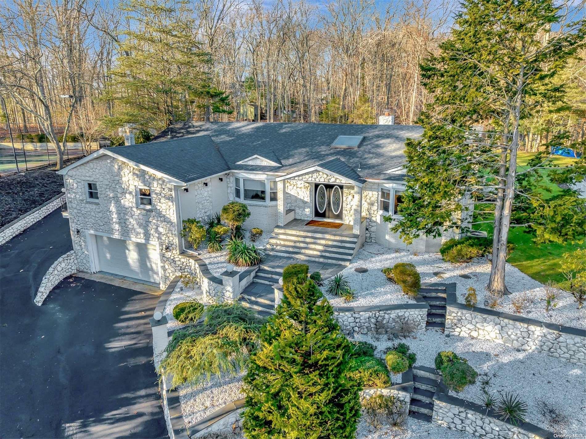 an aerial view of a house with garden and sitting area