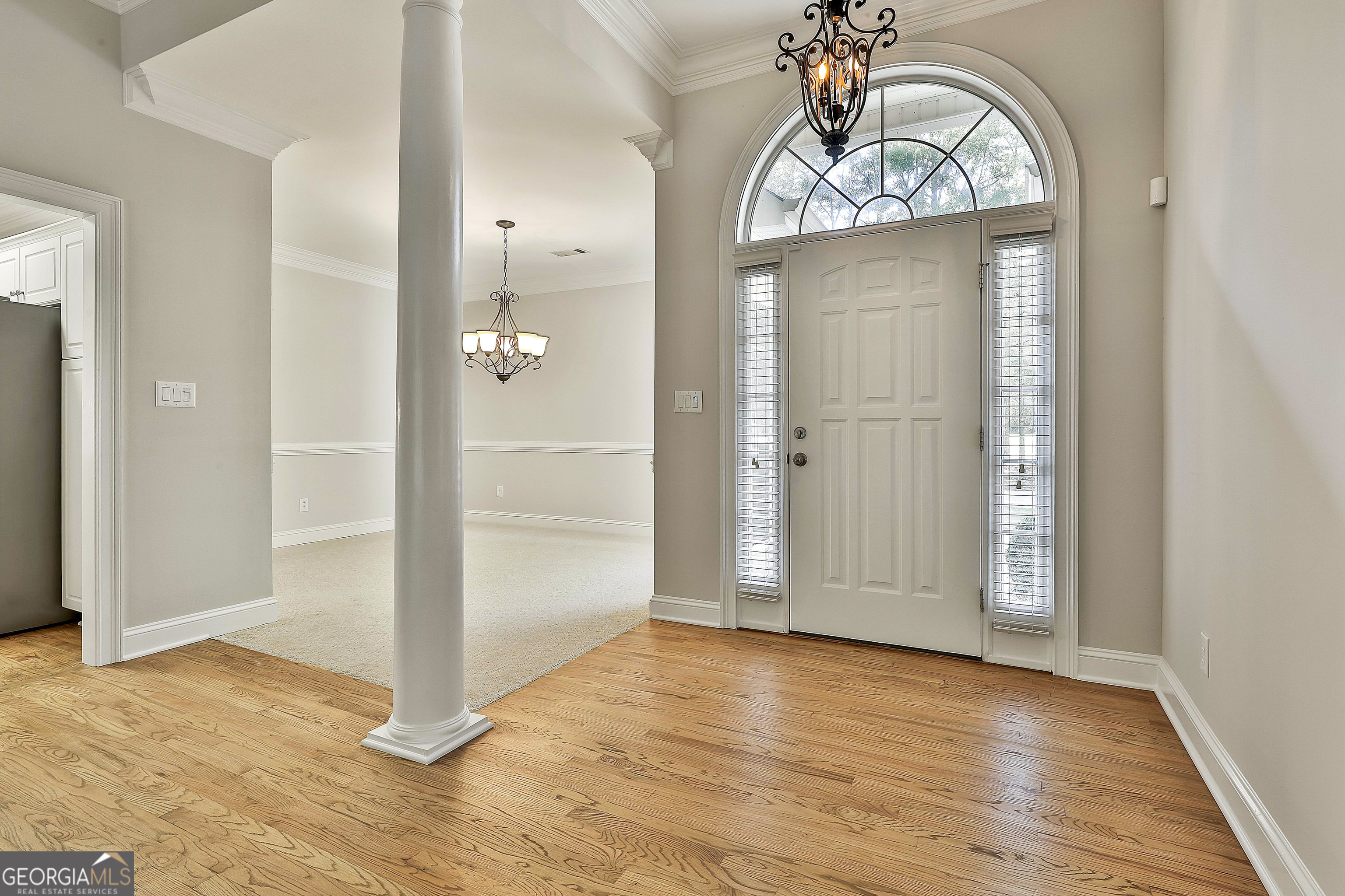 365 Pendleton Trail Tyrone, GA 30290 - Photo 11 of 55 an empty room with wooden floor mirror and windows