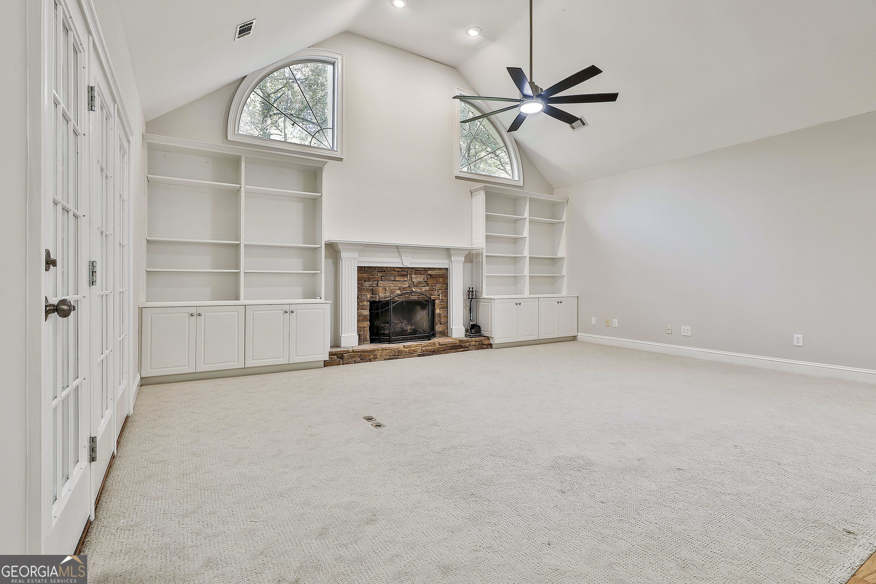 365 Pendleton Trail Tyrone, GA 30290 - Photo 18 of 55 an empty room with a fireplace and a ceiling fan