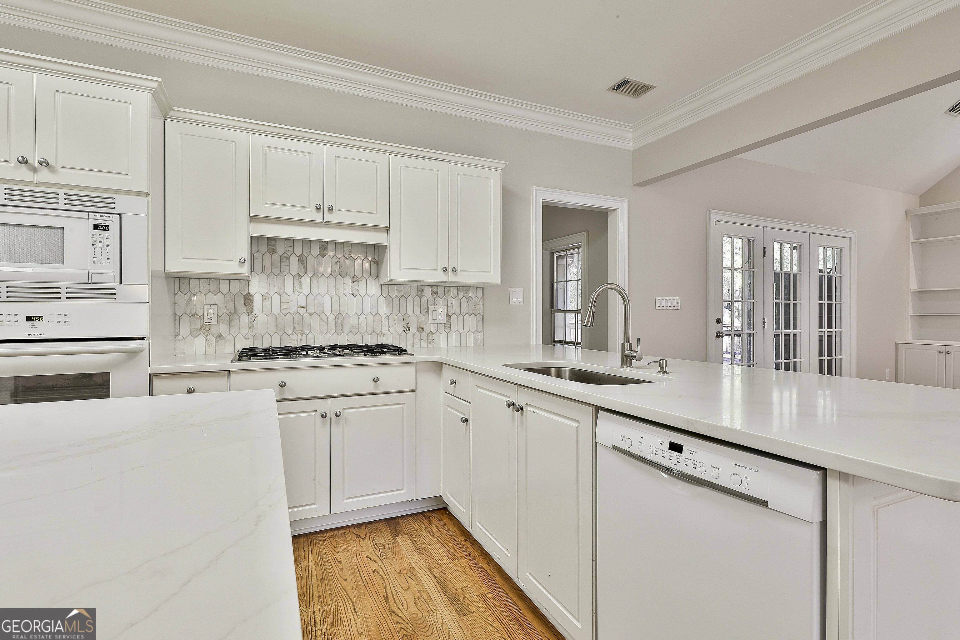 365 Pendleton Trail Tyrone, GA 30290 - Photo 25 of 55 a kitchen with granite countertop white cabinets and white appliances