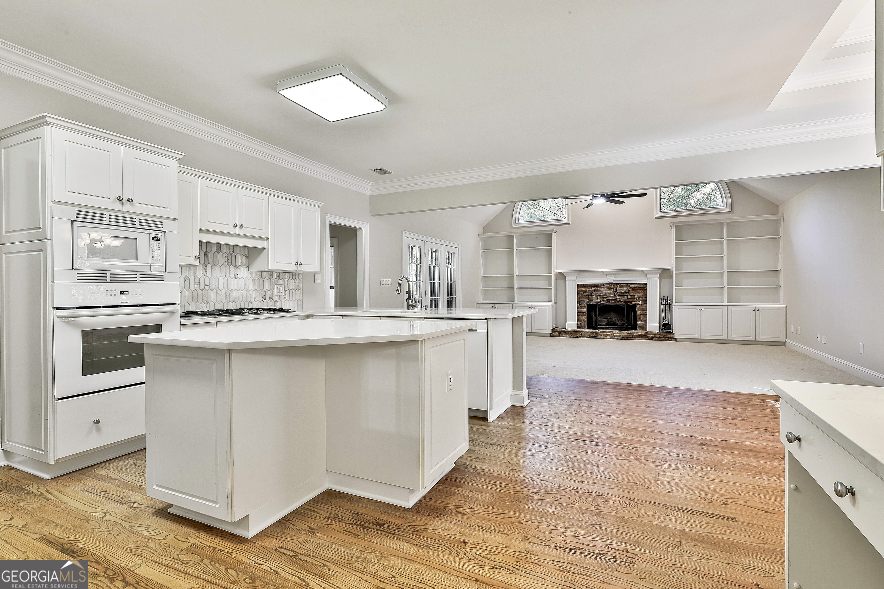 365 Pendleton Trail Tyrone, GA 30290 - Photo 33 of 55 a large kitchen with cabinets and wooden floor