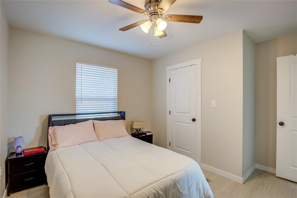 521 Private Road Brookston, TX 75421 - Photo 12 of 26 a bedroom with a bed and a chandelier