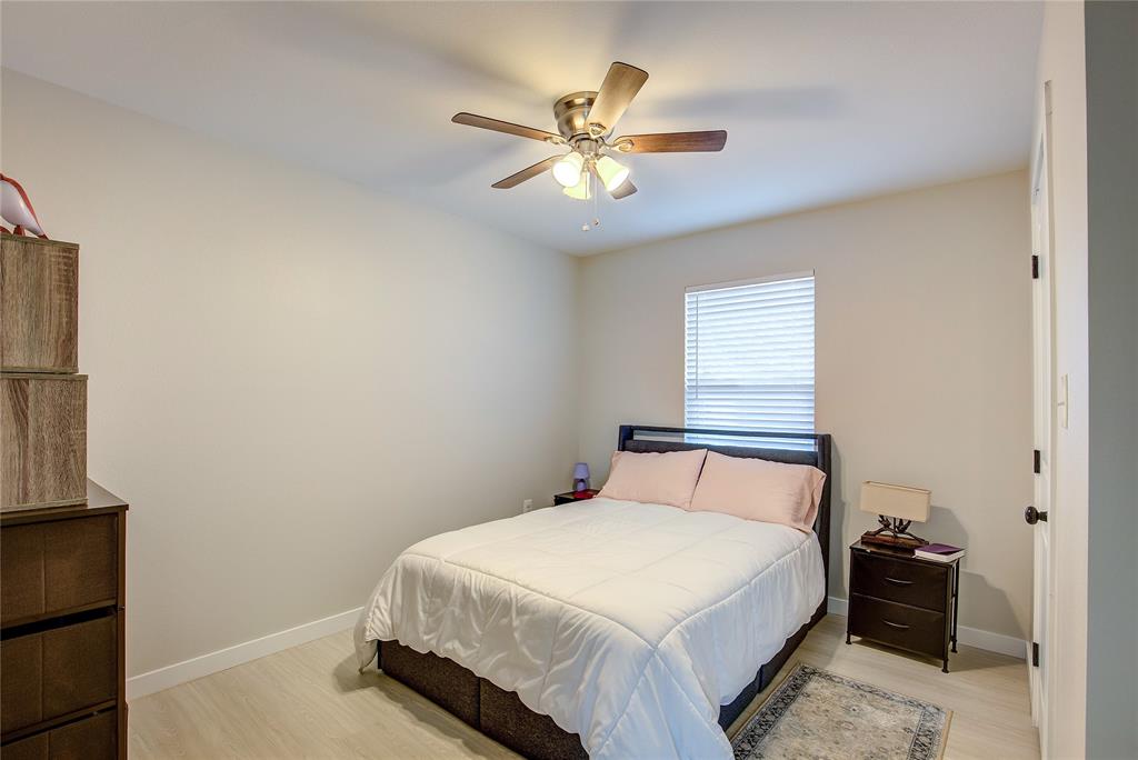 521 Private Road Brookston, TX 75421 - Photo 13 of 26 a bedroom with a bed and a ceiling fan