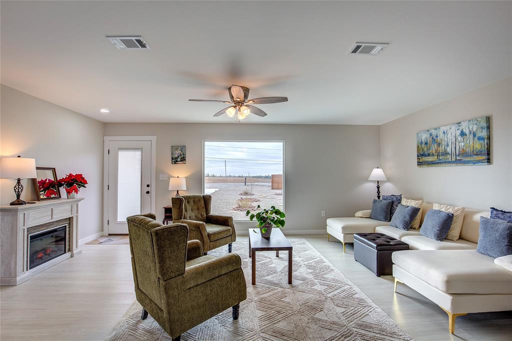521 Private Road Brookston, TX 75421 - Photo 2 of 26 a living room with furniture and a fireplace