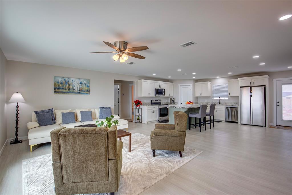 521 Private Road Brookston, TX 75421 - Photo 4 of 26 a living room with couches and kitchen view with wooden floor