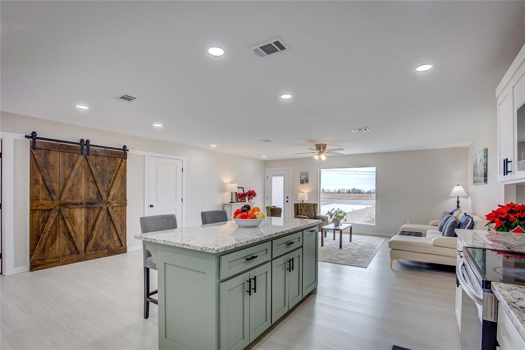 521 Private Road Brookston, TX 75421 - Photo 5 of 26 a kitchen that has a lot of cabinets and couches with wooden floor