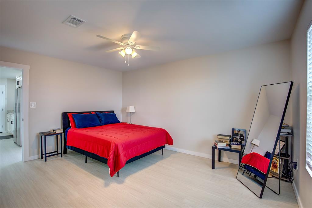 521 Private Road Brookston, TX 75421 - Photo 9 of 26 a bedroom with a bed and a chandelier