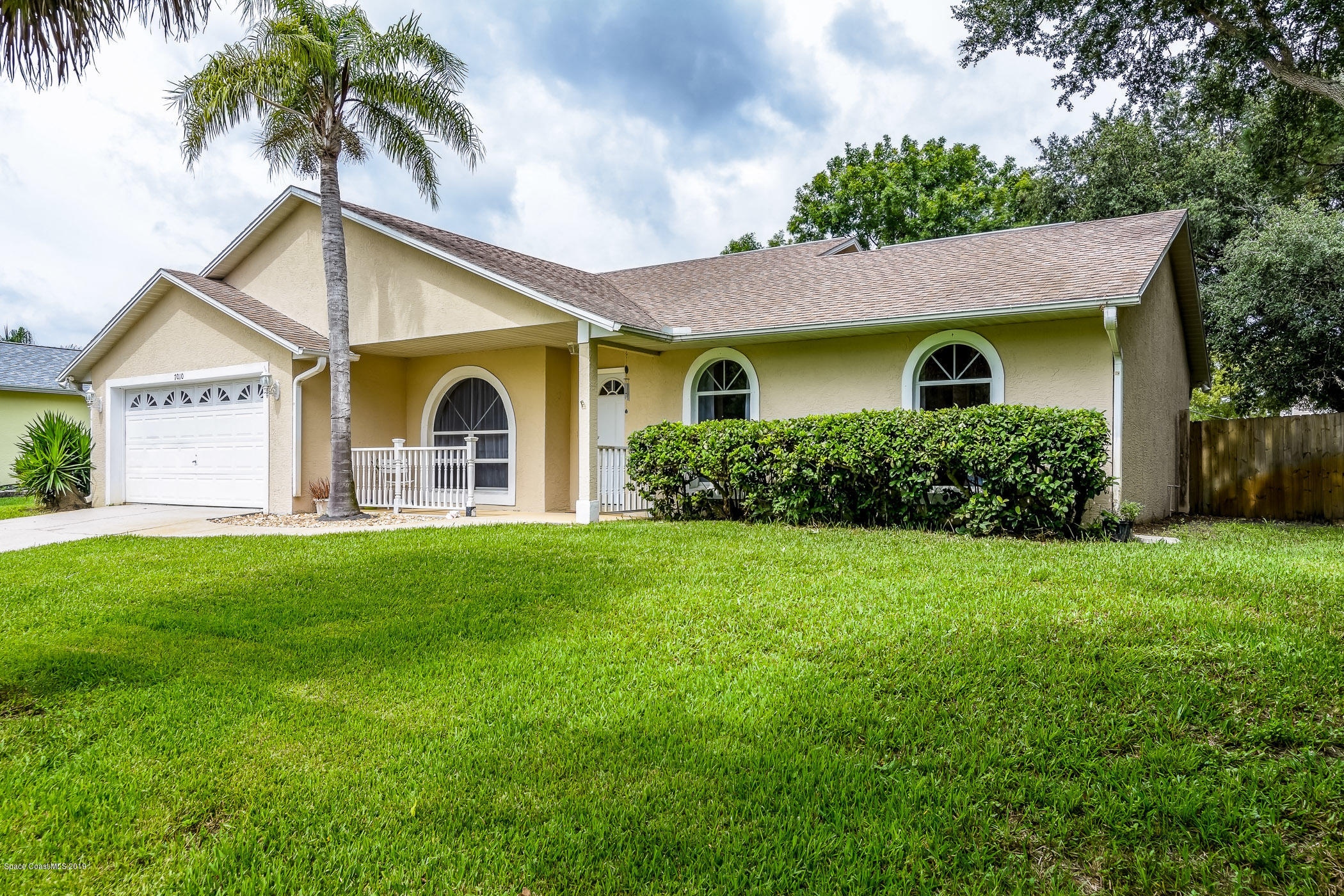 7010 Cairo Road Cocoa, FL 32927 - Photo 2 of 22 a front view of house with yard and green space