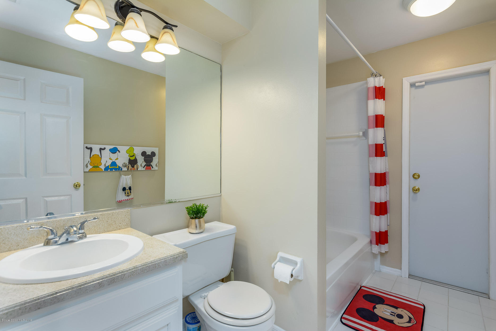 7010 Cairo Road Cocoa, FL 32927 - Photo 12 of 22 a bathroom with a sink a toilet and a mirror