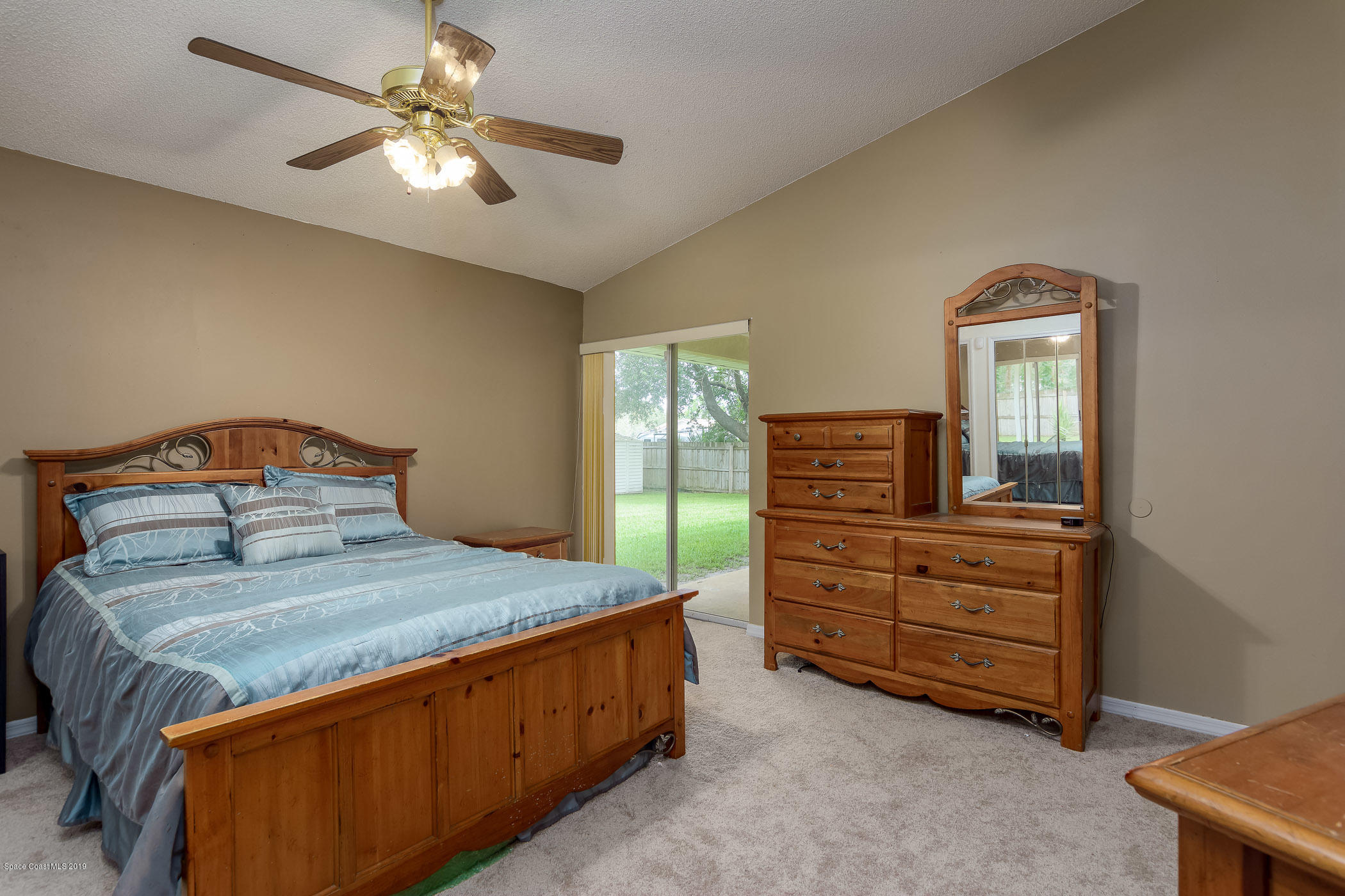 7010 Cairo Road Cocoa, FL 32927 - Photo 14 of 22 a bedroom with a bed and a dresser