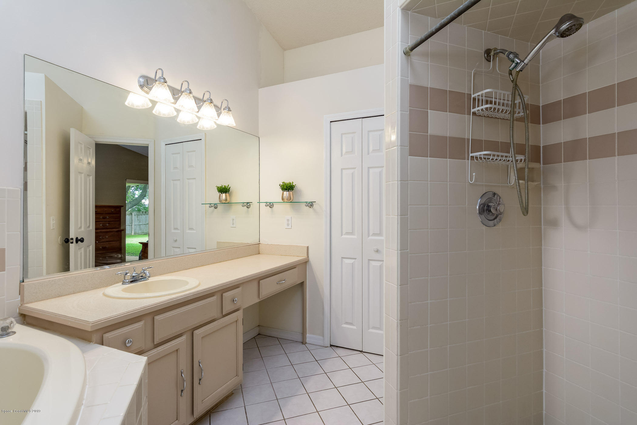 7010 Cairo Road Cocoa, FL 32927 - Photo 17 of 22 a bathroom with a sink vanity and shower