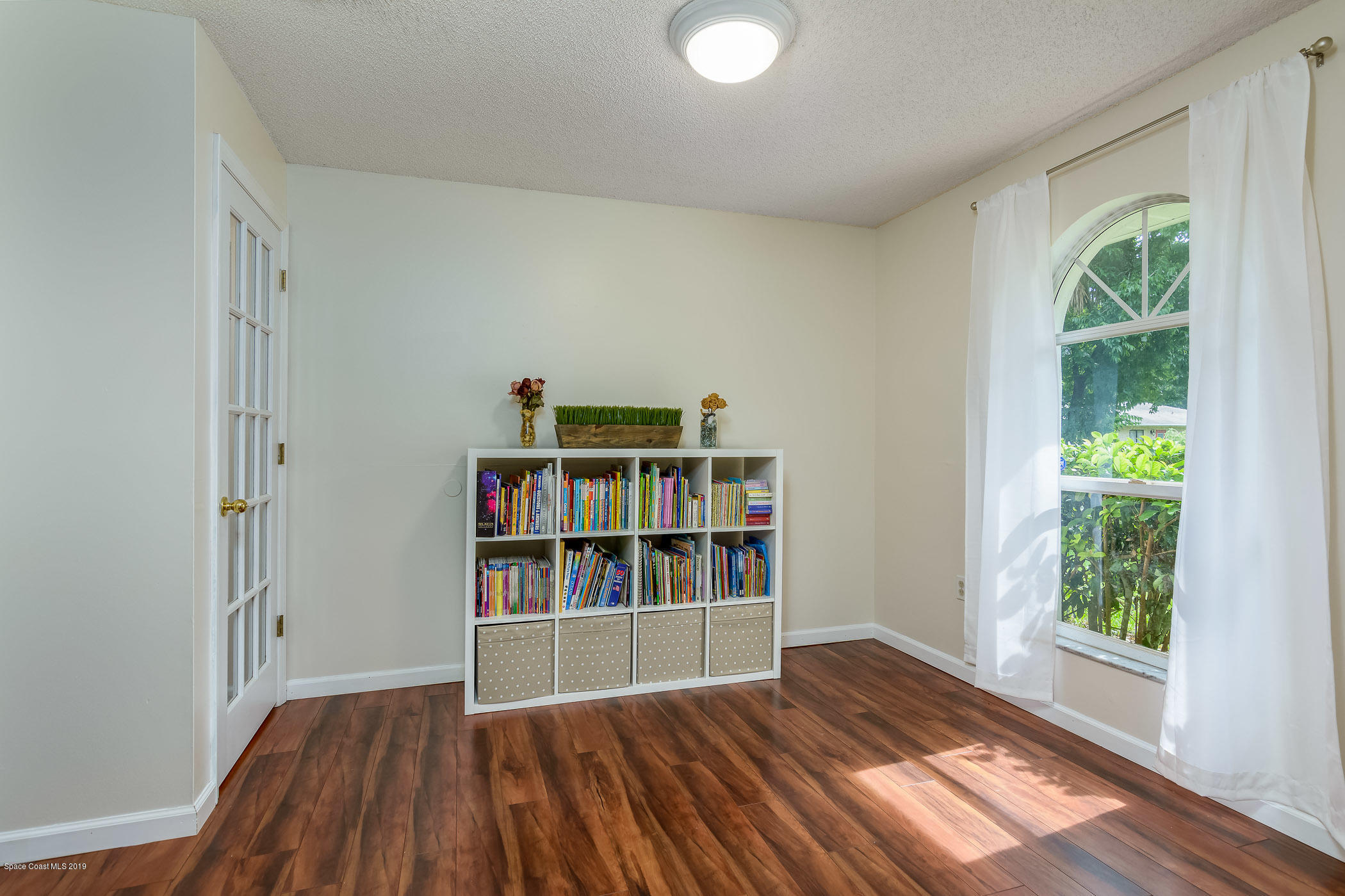 7010 Cairo Road Cocoa, FL 32927 - Photo 6 of 22 a view of empty room with wooden floor and fan