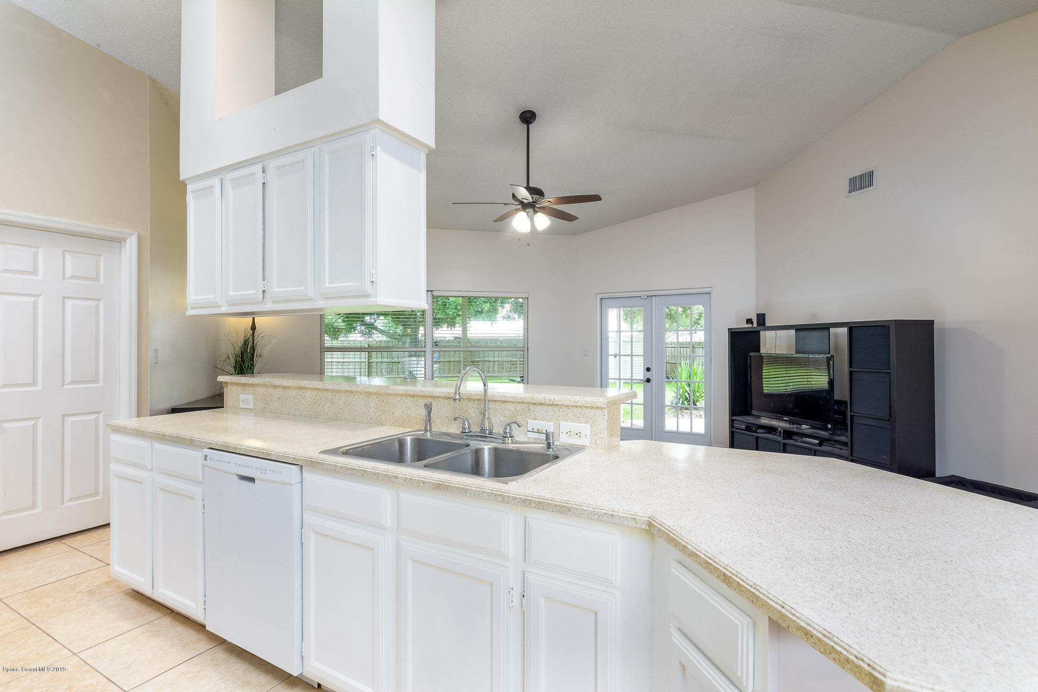 7010 Cairo Road Cocoa, FL 32927 - Photo 8 of 22 a kitchen with a sink and a large mirror