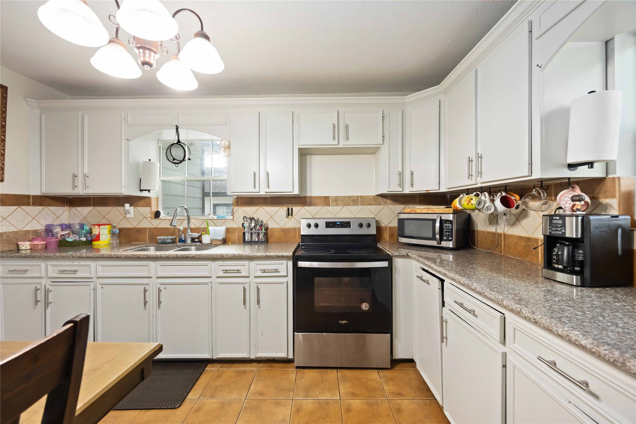 5119 Terry Street Houston, TX 77009 - Photo 11 of 30 a kitchen with stainless steel appliances granite countertop a sink a stove and cabinets