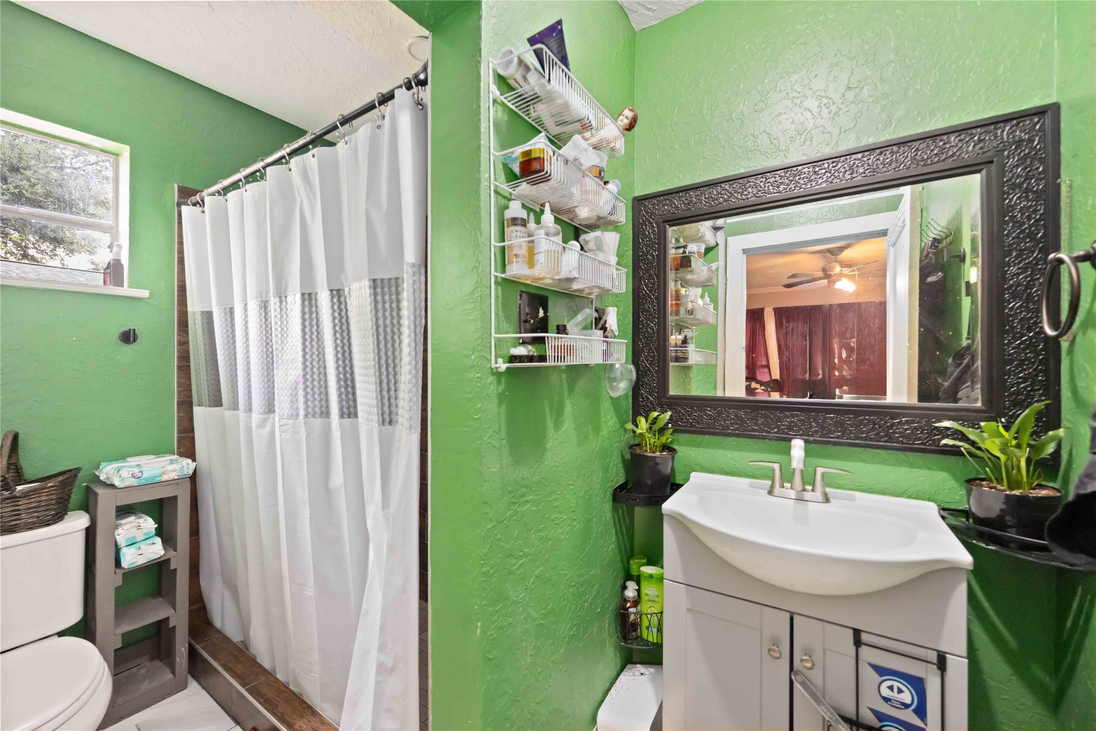 5119 Terry Street Houston, TX 77009 - Photo 14 of 30 a bathroom with a sink a toilet and a mirror