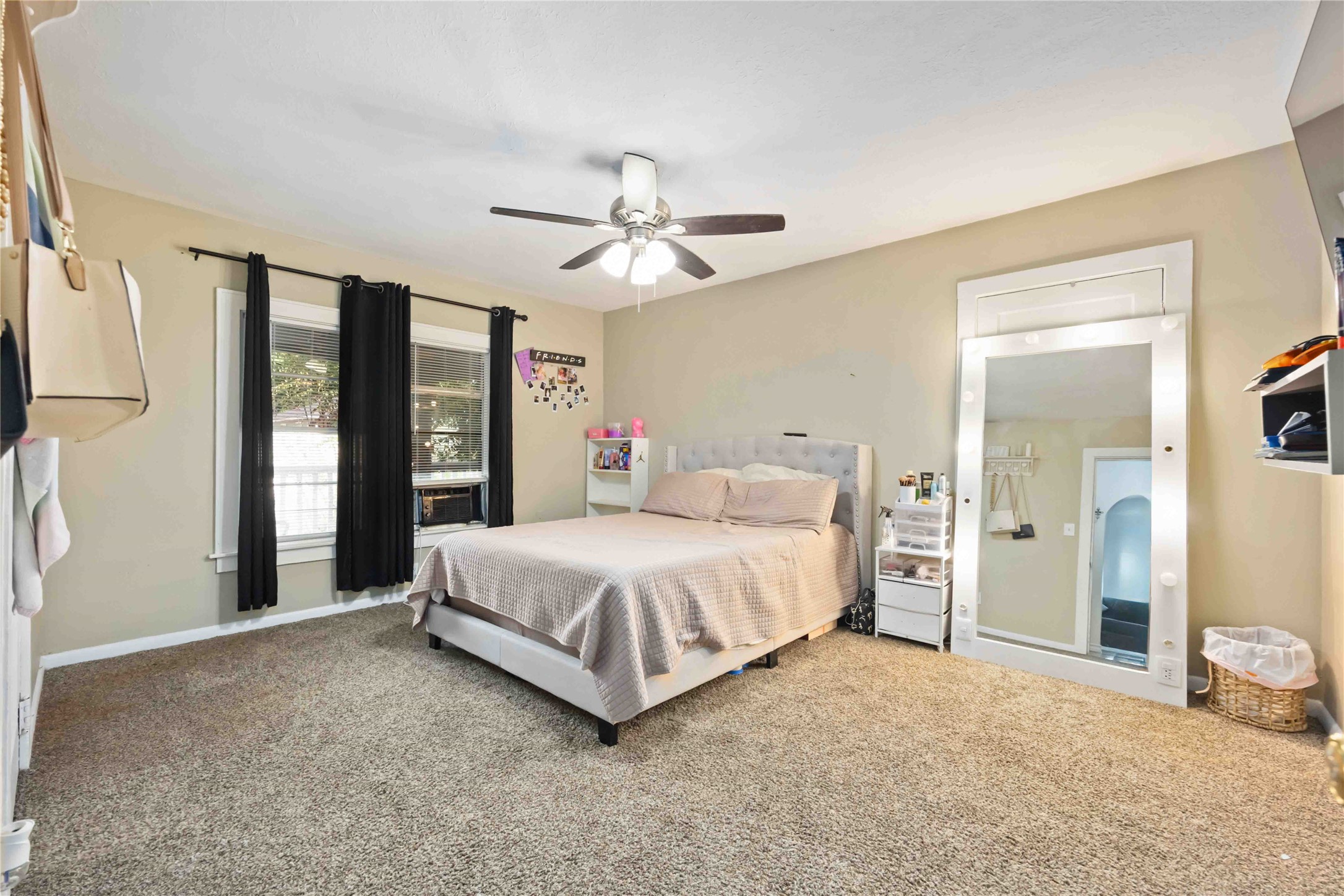 5119 Terry Street Houston, TX 77009 - Photo 16 of 30 a spacious bedroom with a large bed and a chandelier