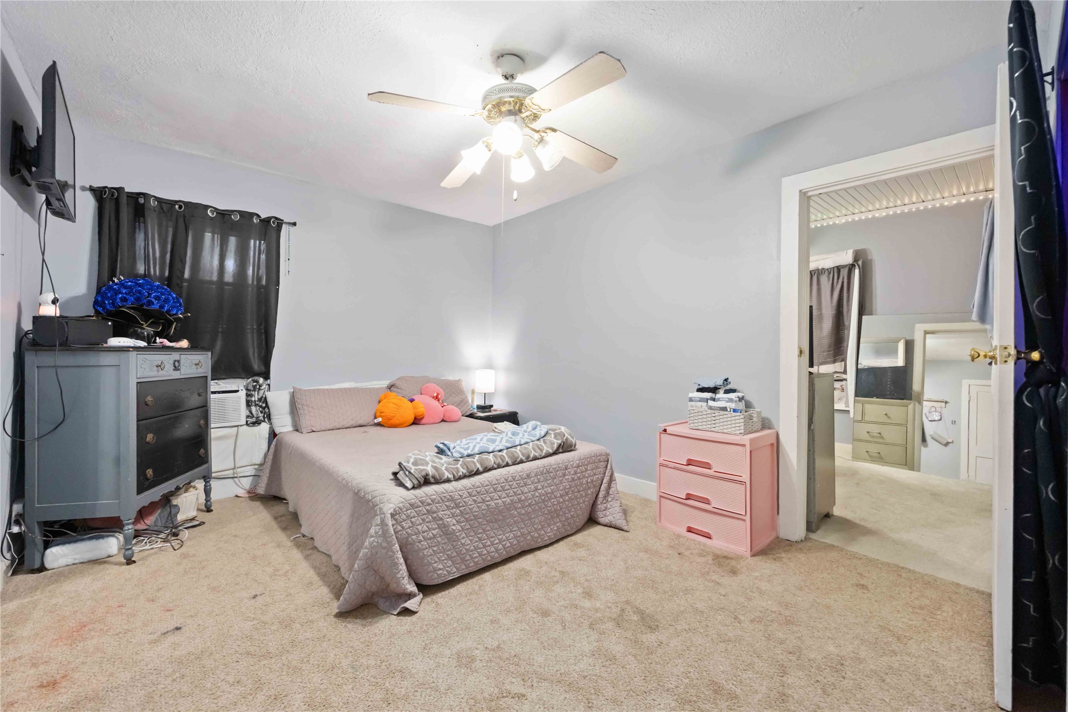 5119 Terry Street Houston, TX 77009 - Photo 17 of 30 a bedroom with a bed and a chandelier