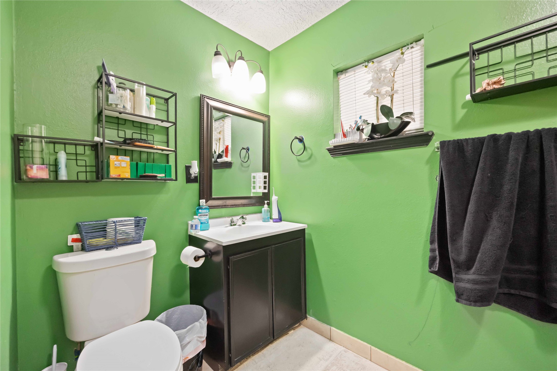5119 Terry Street Houston, TX 77009 - Photo 18 of 30 a bathroom with sink toilet and mirror