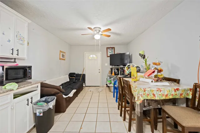 a kitchen with a refrigerator sink and cabinets