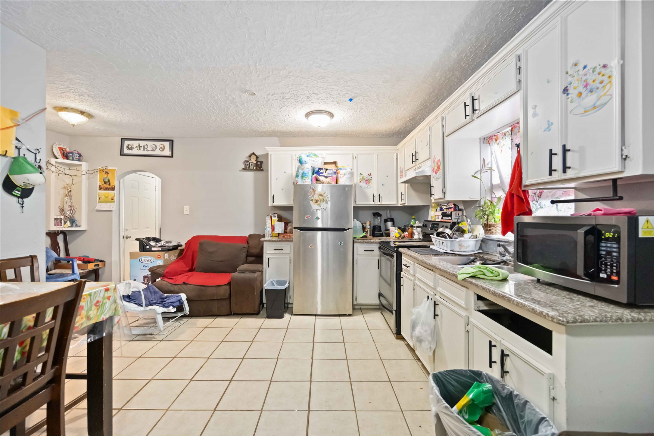 5119 Terry Street Houston, TX 77009 - Photo 25 of 30 a kitchen with stainless steel appliances a stove top oven a sink dishwasher and a refrigerator with the cabinets