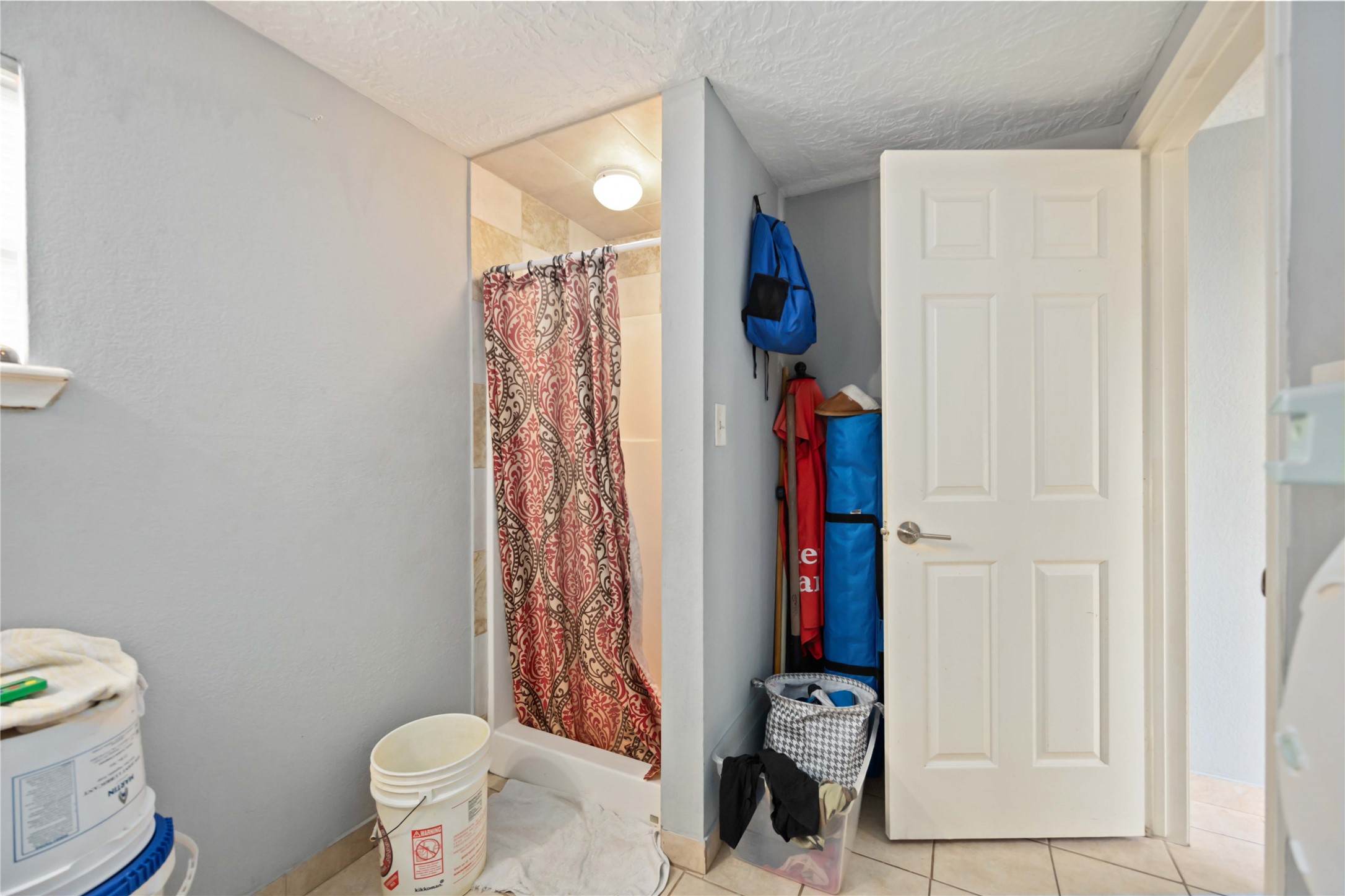 5119 Terry Street Houston, TX 77009 - Photo 27 of 30 a view of bathroom with a toilet and a shower curtain
