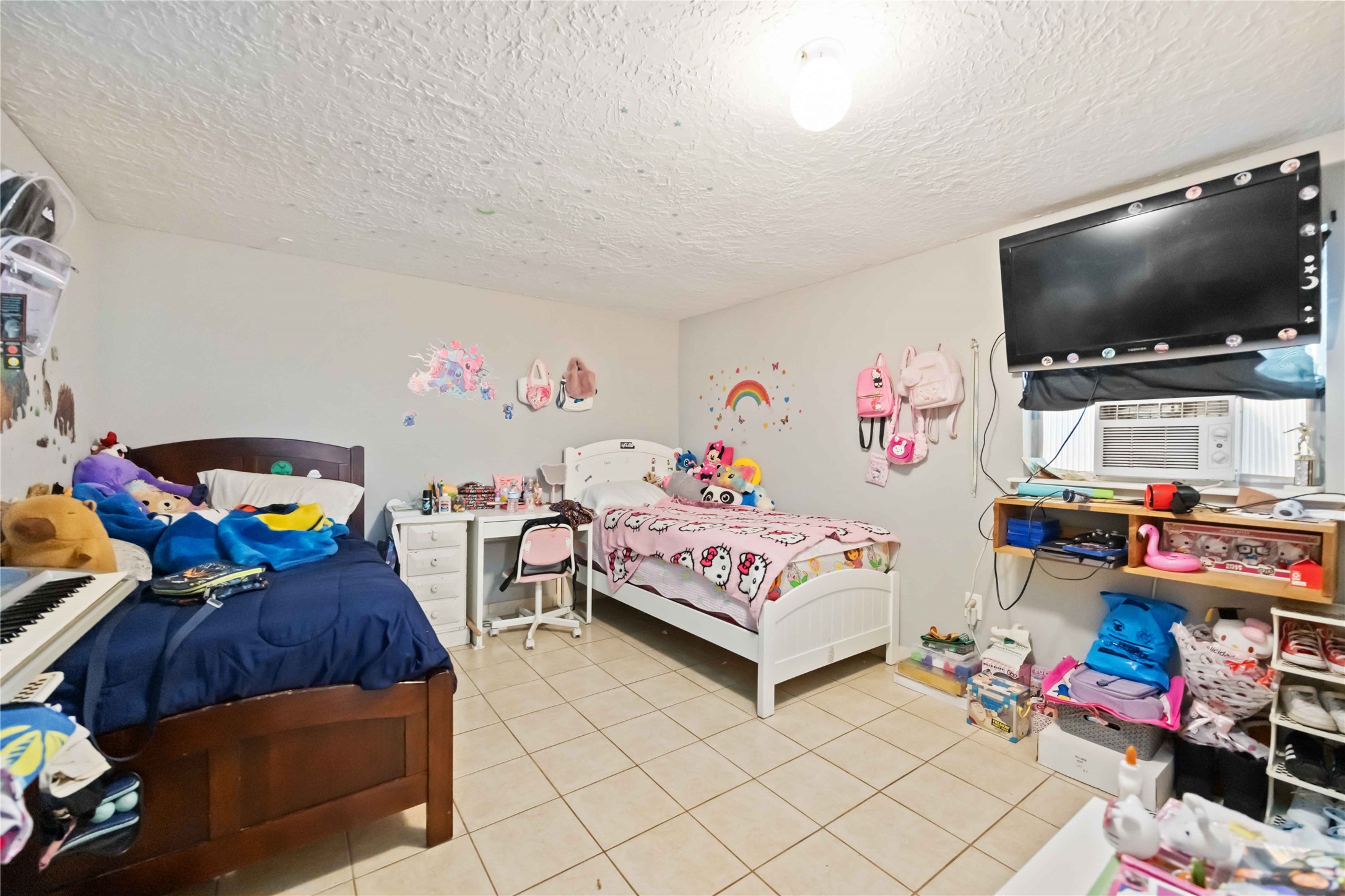 5119 Terry Street Houston, TX 77009 - Photo 29 of 30 a bedroom with baby toys and flat screen tv