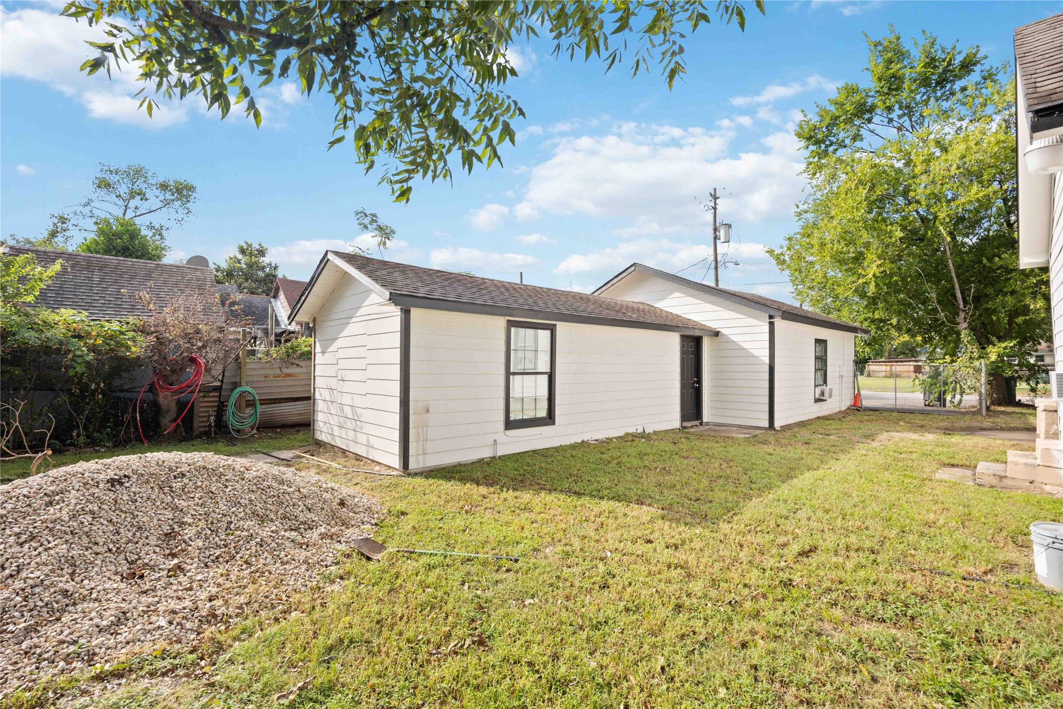 5119 Terry Street Houston, TX 77009 - Photo 30 of 30 a backyard of a house with large trees and plants