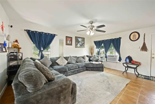a living room with furniture and a flat screen tv