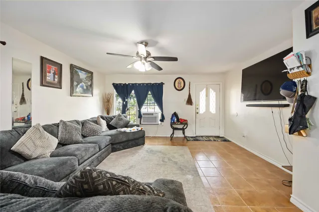 a living room with stainless steel appliances lots of furniture and kitchen view