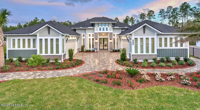 a front view of a house with a yard and pathway