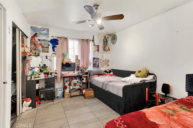 a bedroom with bed and a window