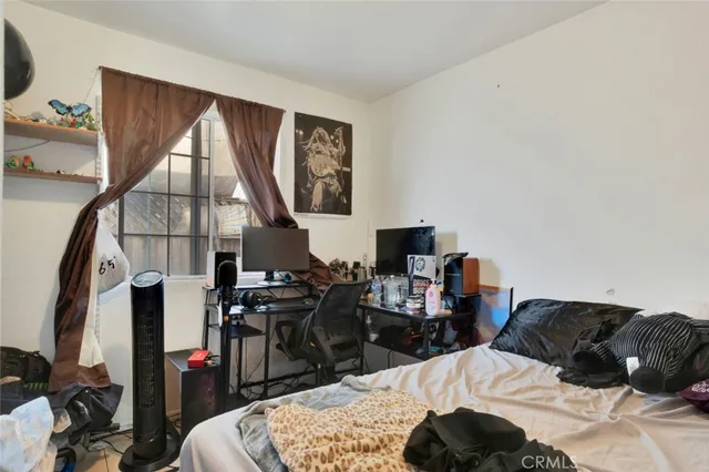 a bedroom with a bed a desk and chair