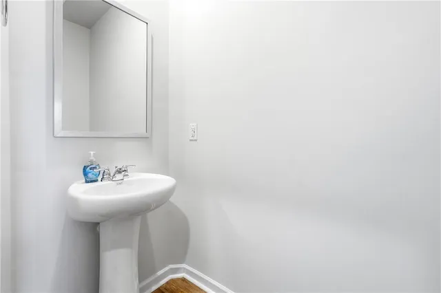 a bathroom with a sink a mirror and a toilet