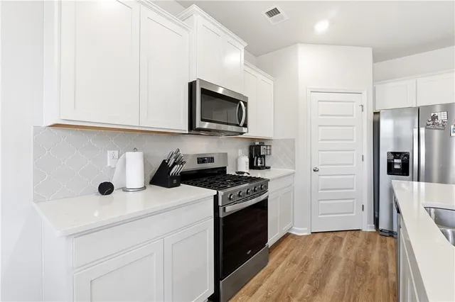 a kitchen with a stove microwave and refrigerator