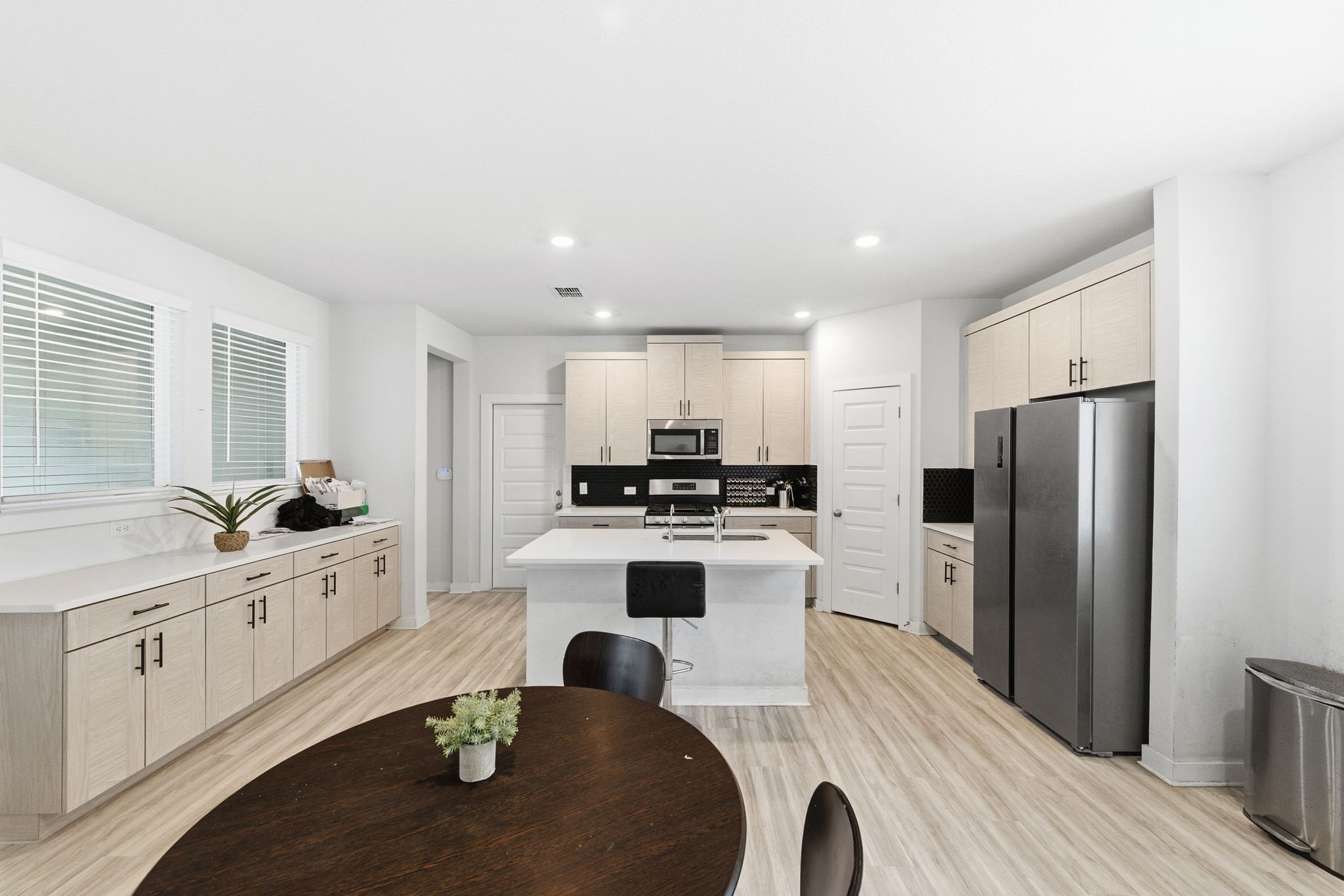 241 Banff Drive Kyle, TX 78640 - Photo 12 of 28 a kitchen with kitchen island a white counter top space a sink stainless steel appliances and cabinets