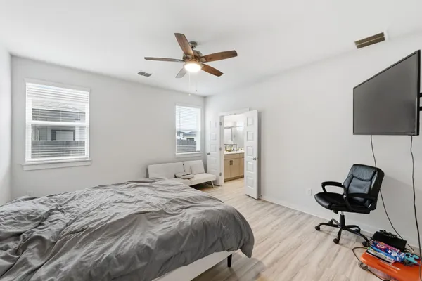 a bedroom with a bed and a window