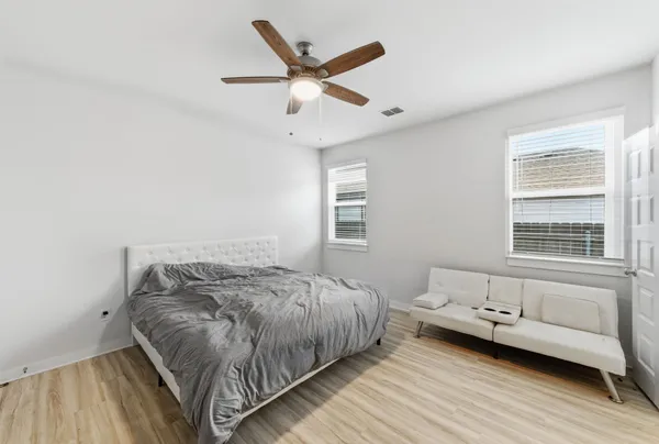 a bedroom with a bed and a window