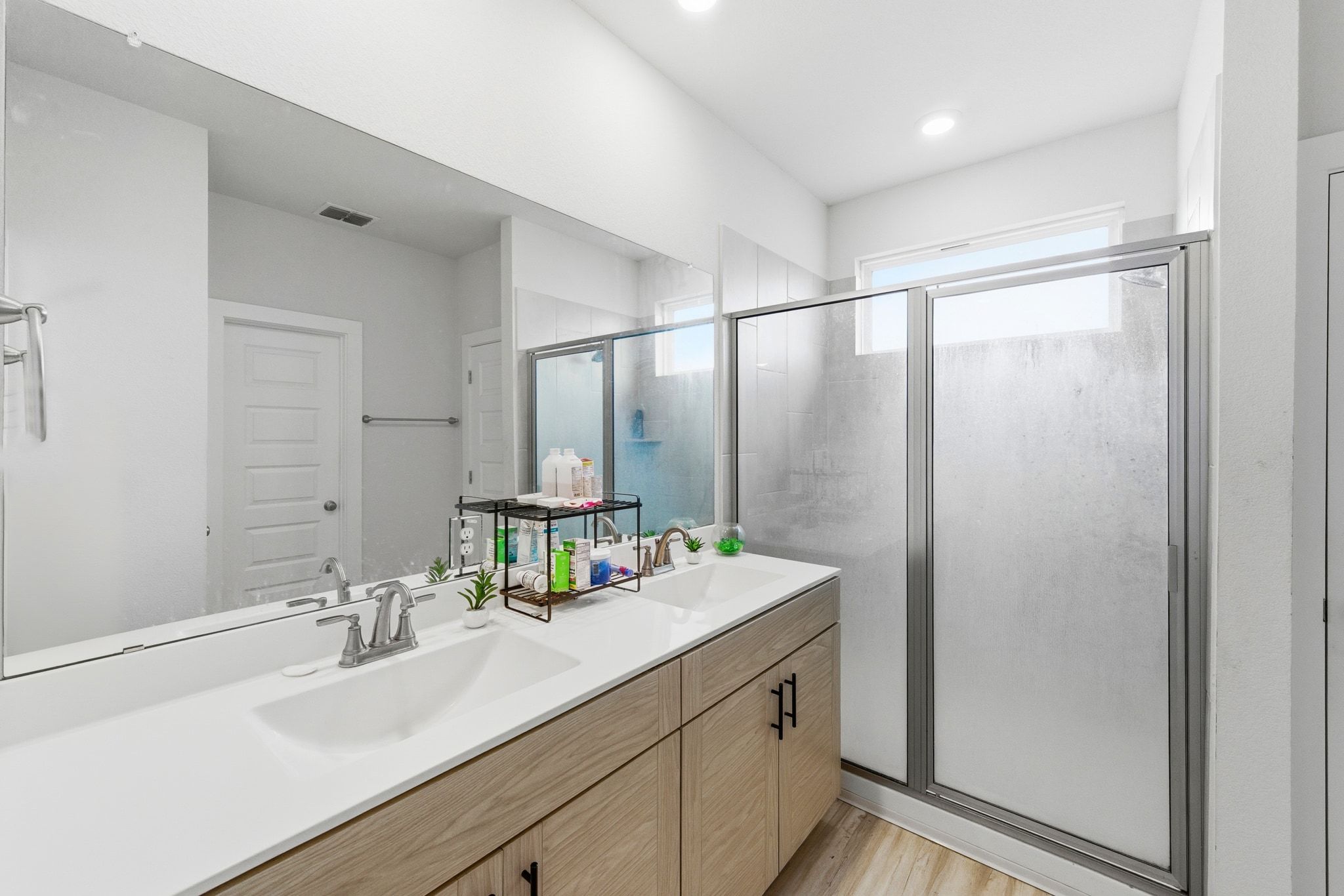241 Banff Drive Kyle, TX 78640 - Photo 15 of 28 a bathroom with double vanity sink and a mirror