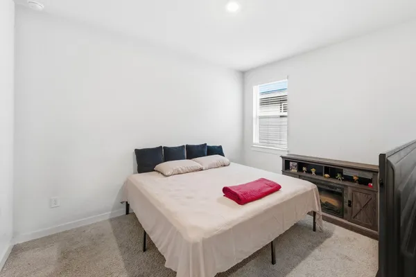 a bedroom with a bed and a dresser